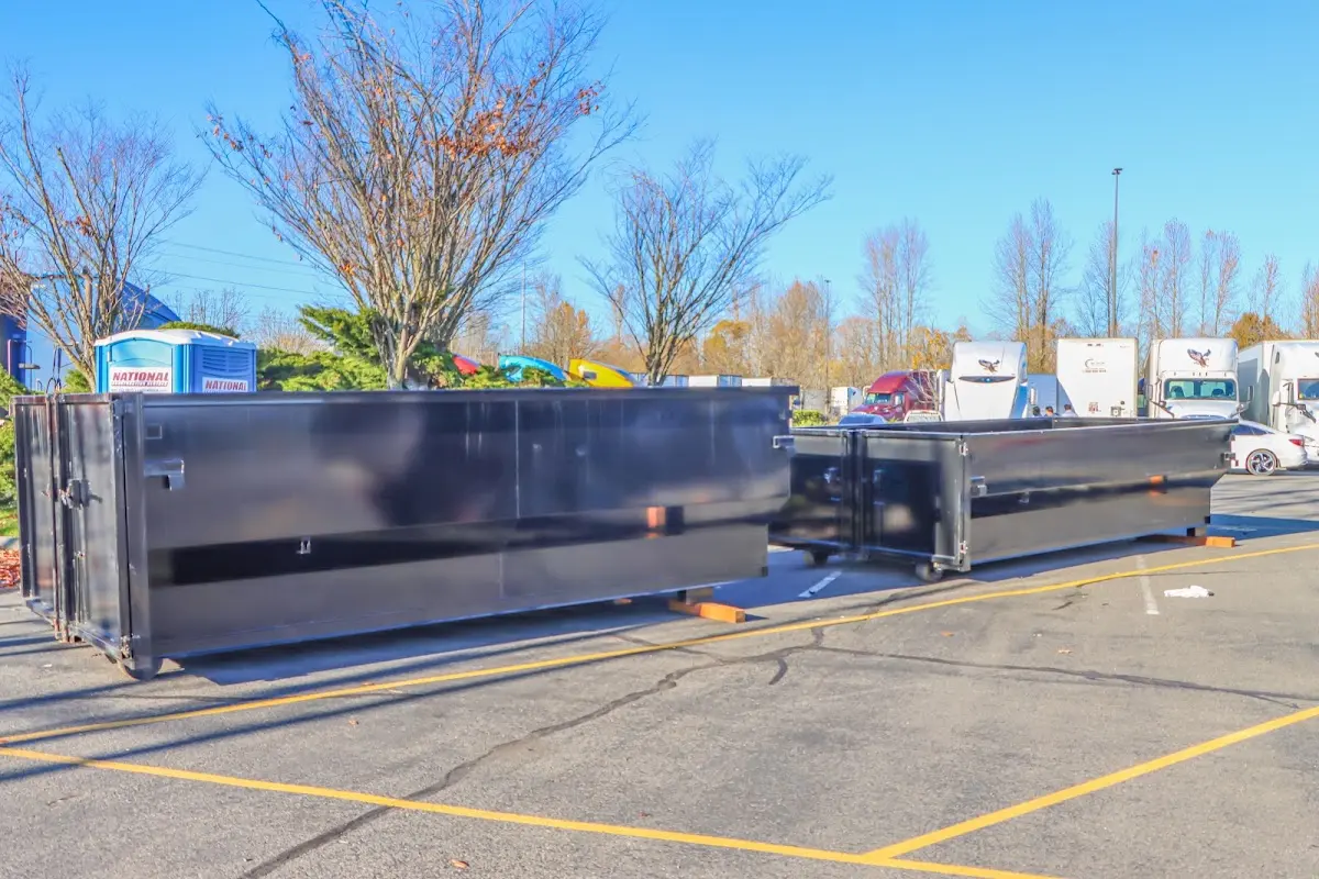 Professional dumpster rental service with roll-off container on residential driveway in Katy